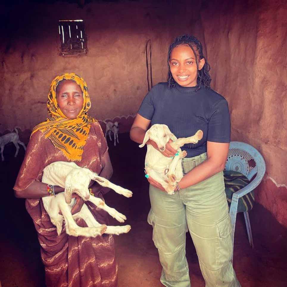 Dr. Grace and Kenyan woman holding infant goats